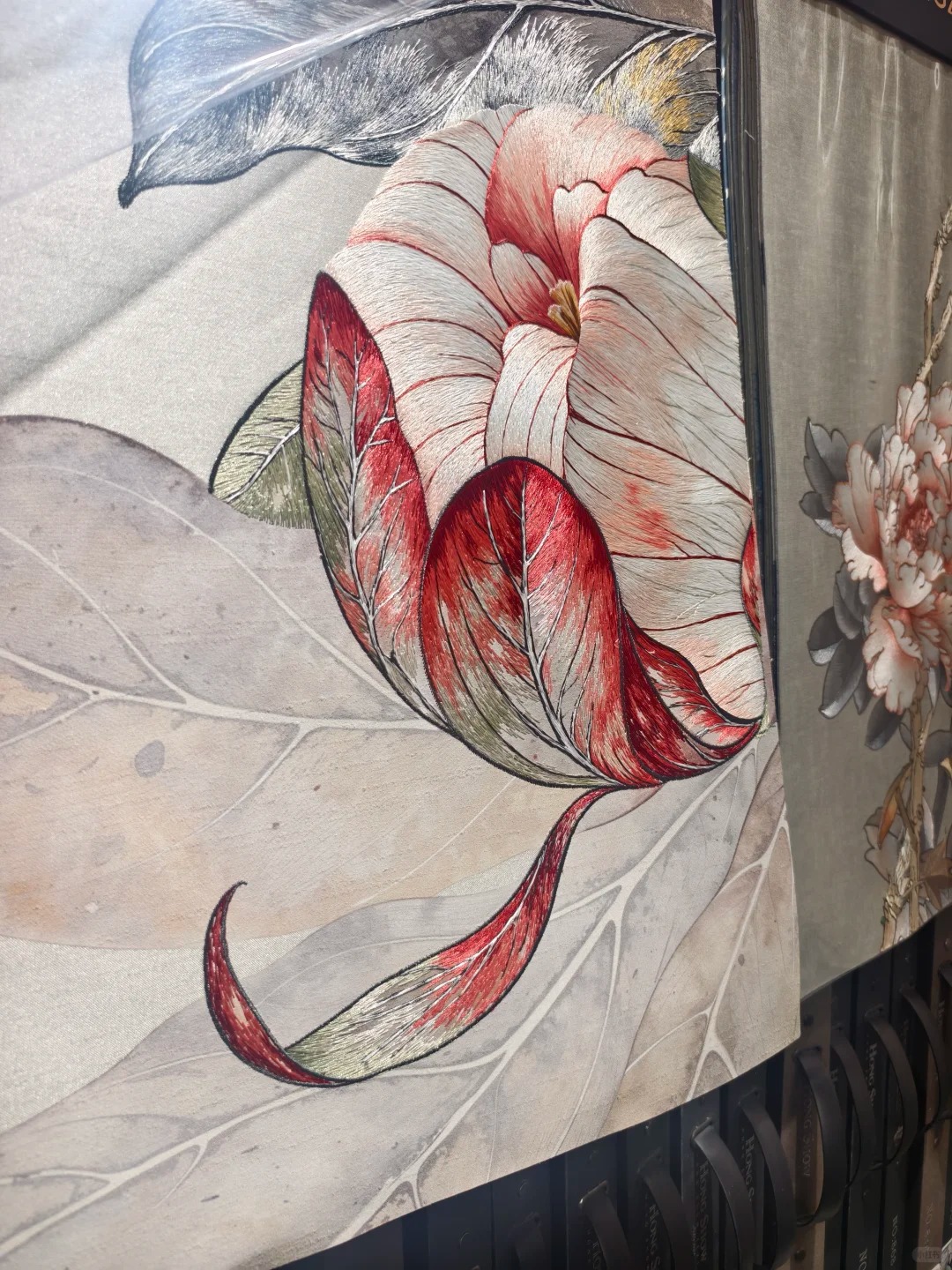Close-up of red and ivory floral embroidery on wallcovering