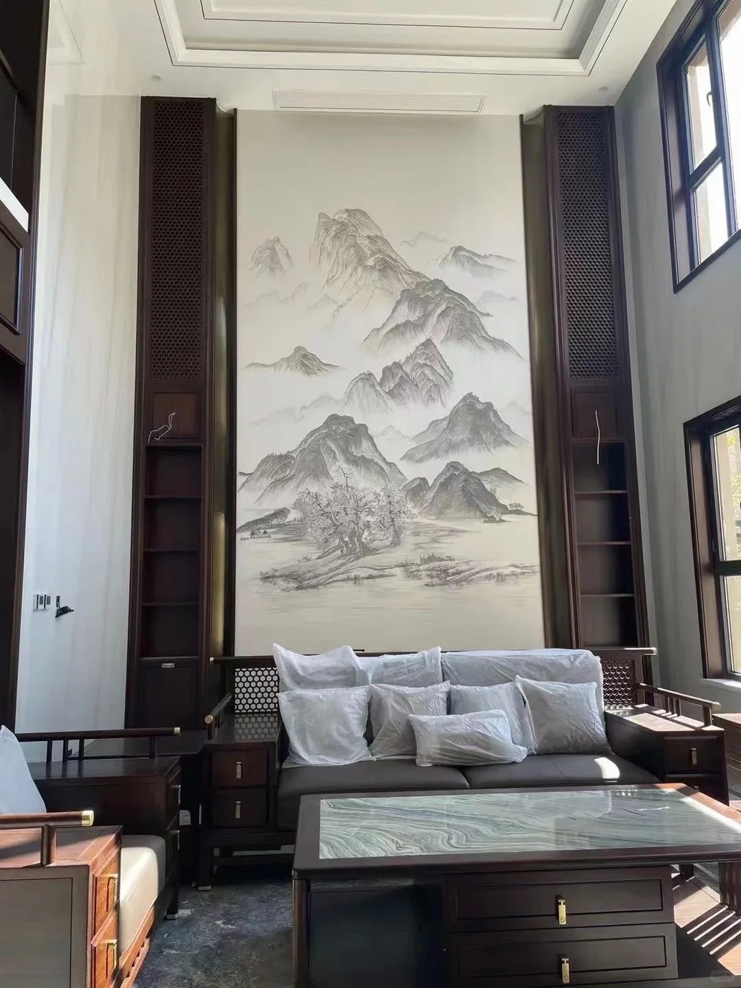 Tall living room with landscape feature wall and seating