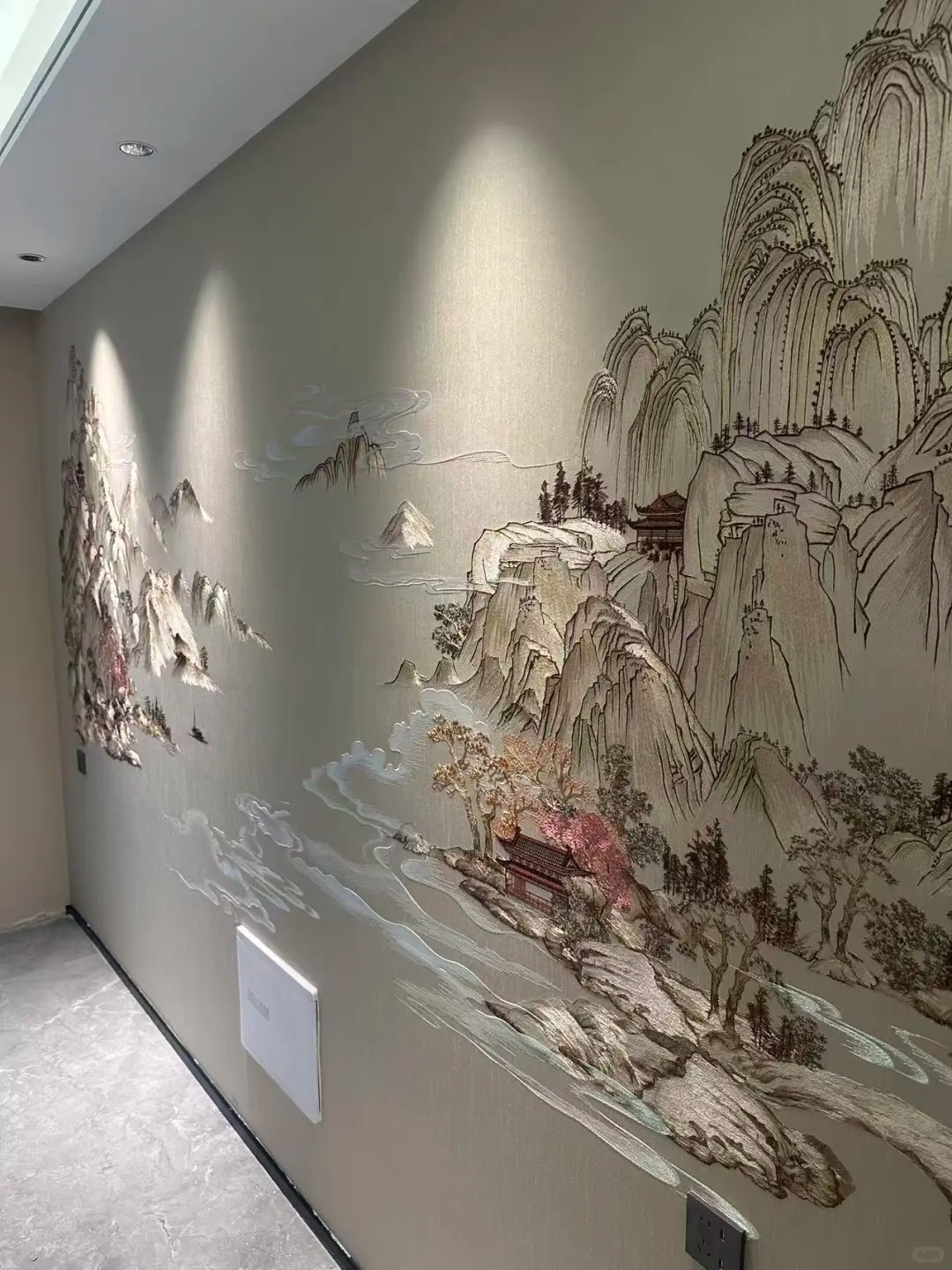Corridor wall with large embroidered landscape mural